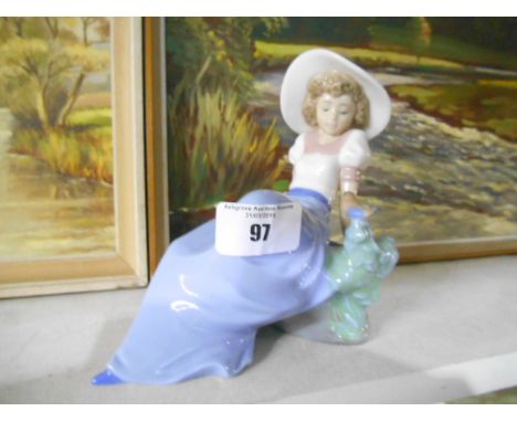 A Nao Figure of a Seated Girl & Bird Beside