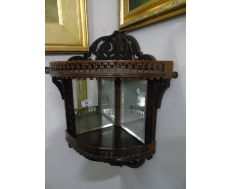 An Edwardian Mahogany Corner Shelf with fretwork decoration and mirror back