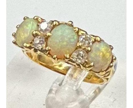 An 18ct gold three opal and diamond ring, approximate size J and weight 5g.