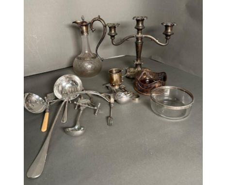 A quantity of silver plate and white metal items to include flatware, a decanter and a candlestick 
