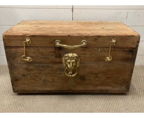A pine trunk with gilt lion handles 