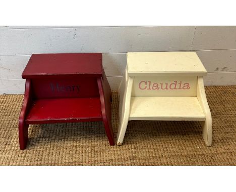 Two personalized children's step footstools, one in red personalized Henry and the other white personalized Claudia 