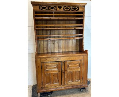 A vintage pine Welsh dresser, three shelf plate rack and two cupboard under