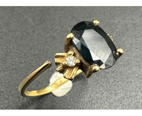 An 18ct gold sapphire ring with diamond shoulders AF