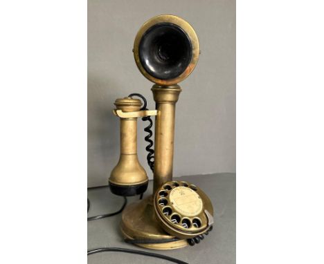 A brass rotary candlestick telephone 