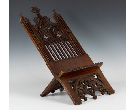 A 19th Century Gothic Revival walnut folding book stand of architectural form with intricately pierced tracery, height approx