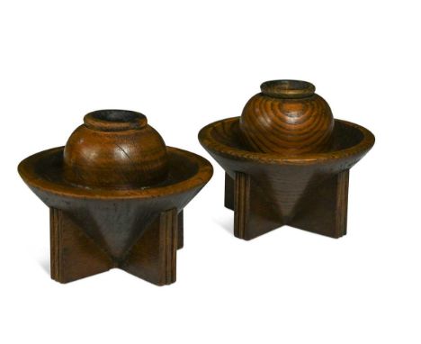 A pair of Art Deco oak candlesticks by Ebenezer Gomme, the urn form scones to conical supports and cruciform bases9 x 11cm