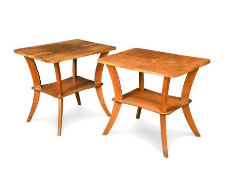 A pair of Art Deco walnut lamp or end tables, each with quarter-veneered figured-walnut rounded-rectangular tops above a sing