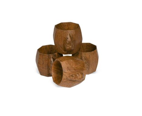 Robert 'Mouseman' Thompson, a group of four oak napkin rings, of octagonal barrel form and each carved with mouse signature5c