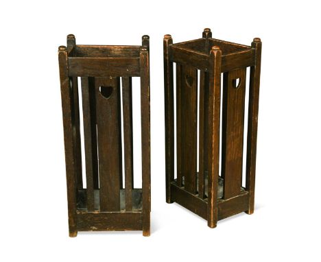 Liberty & Co., a pair of Arts & Crafts oak stick stands, each with pierced heart motifs and original drip pans, one labelled 