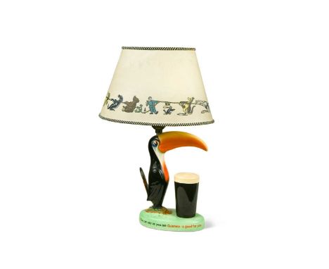 A Carlton Ware Guinness Toucan table lamp, modelled standing beside a pint of Guinness, the slogans 'How Grand To Be a Toucan