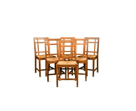 Paul Matt for Brynmawr Furniture, a set of twelve Arts & Crafts oak 'Mount' dining chairs, each with lattice back design and 