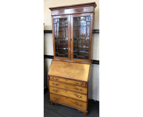 An Edwardian mahogany bureau bookcase with two door glazed top, four drawers to base and satinwood inlaid border on bracket f