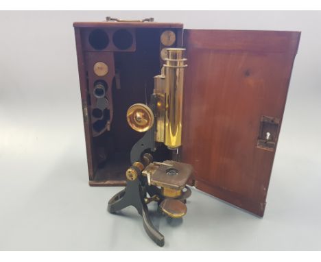 A mahogany cased brass travel microscope, by J.Swift & Son London with various lenses.