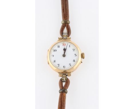 A ladies 15ct yellow gold wrist watch, the white enamel dial having hourly Arabic numerals with minute track border, import h