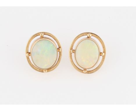 A pair of 9ct yellow gold opal stud earrings, each set with an oval opal cabochon, measuring approx. 12x10mm, with an open me