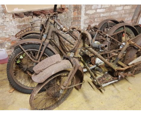 Four Vintage motorcycle frames with accessory parts.