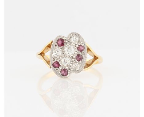 A hallmarked 18ct yellow gold ruby and diamond ring, set with old cut diamonds and round cut rubies to lobe design head, ring