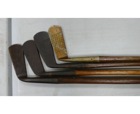 A collection of Vintage Golf Clubs: including 4 Hickory Shafted items, woods, putters etc 