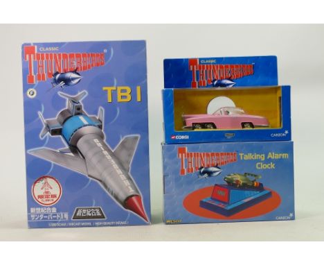 A collection of Thunderbirds items to include: Japanese Aoshma TB1 figure, Carlton Fab1 vehicle and Carlton talking alarm clo