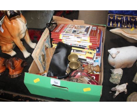 A box containing various magazines; a pipe; glass paperweight; cutlery etc.