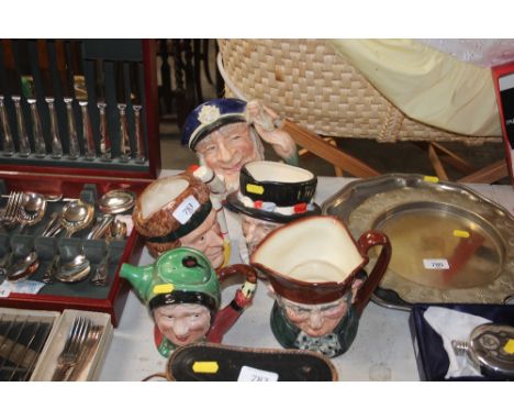 Four Royal Doulton character jugs, "The Juggler"' "Old Charlie", "Beefeater" and "Old Salt"; together with a Beswick novelty 
