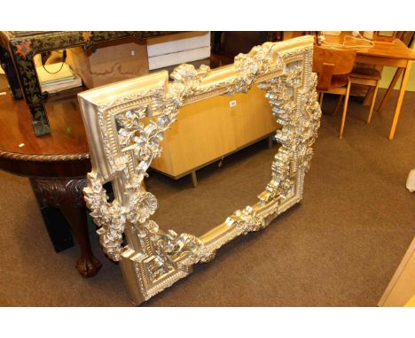 Ornate silvered framed wall mirror