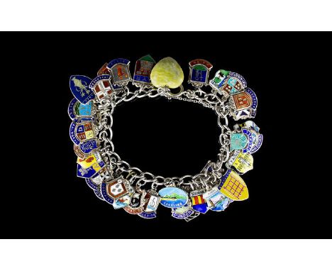 A Vintage Silver Curb Bracelet Loaded with enamel on silver shield medallions of town crests, over 40 in total, all in excell