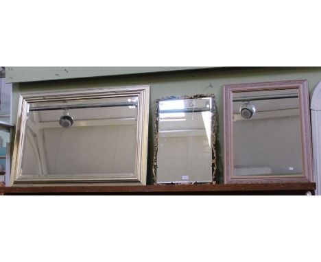 A gilt framed wall mirror together with two others