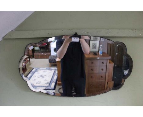 An Art Deco cloud shaped bevel plate wall mirror