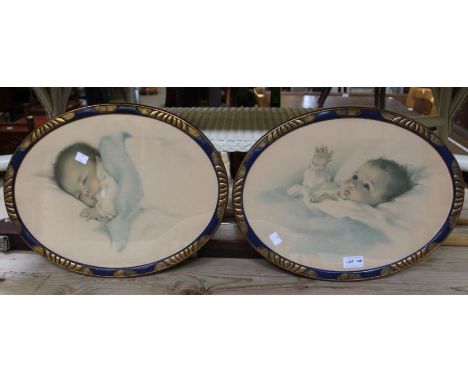 A pair of framed baby prints