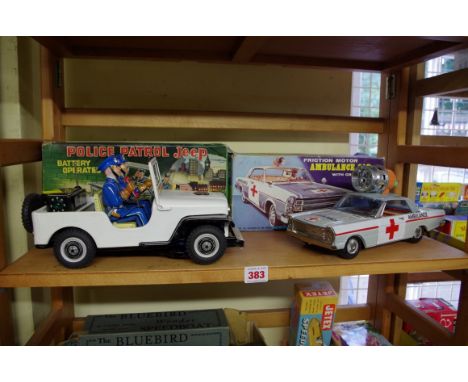 A vintage Made in Japan battery operated tinplate Police Patrol Jeep;&nbsp;together with a similar friction motor Ambulance C