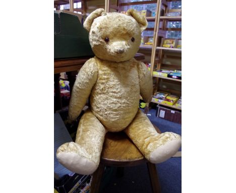 A vintage large golden mohair teddy bear, approx 76cm long; together with another smaller plush bear, approx 45cm long.