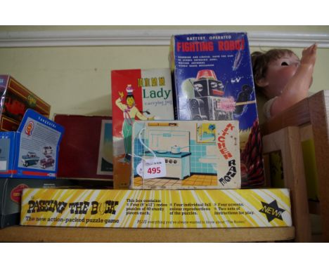 A group of vintage toys and games,&nbsp;to include: a tinplate child's kitchen range; a 'Fighting Robot; 'Passing the Buck' b