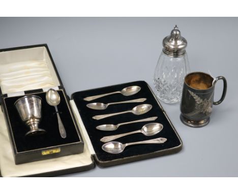 A cased silver christening egg cup and spoon, a set of six silver teaspoons, a silver christening mug and mounted caster.