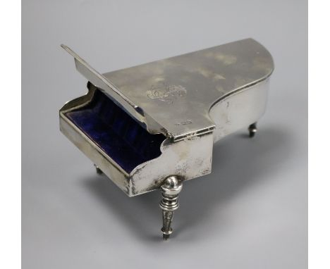 An Edwardian novelty silver trinket box modelled as a grand piano, by William Comyns, London, 1902, 18.5cm.