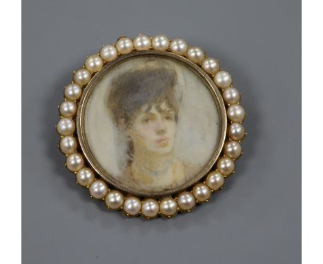 A yellow metal and split pearl mounted circular miniature portrait brooch, 41mm.