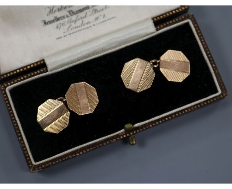 A cased pair of engine turned 9ct gold octagonal cufflinks.