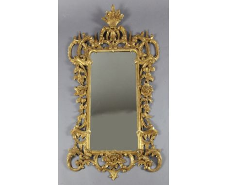 A late 19th century Chippendale style giltwood and gesso rococo carved wood wall mirror, the mirror with foliate scroll borde