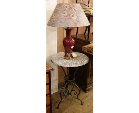 A wrought iron circular tripod table and a lamp W.49.5cm