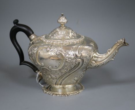 A Victorian embossed silver inverted pear shaped teapot, London, 1890, gross 25 oz.