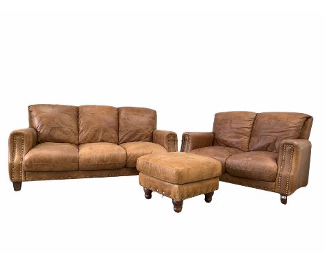 Traditional brown leather upholstered in studded tan leather, (W185cm) together with a matching two seat sofa (W138cm) and fo