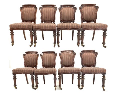 Set eight Victorian mahogany dining chairs, cartouche shaped backs with applied carved floral roundels, upholstered in stripe
