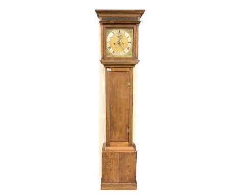 An oak longcase with a step topped hood, deep concave moulding and blind fretted frieze to front, square glazed hood door wit