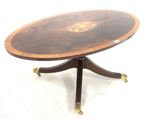 Reproduction Regency design mahogany coffee table, the oval satinwood cross banded top centred with floral inlay, over turned