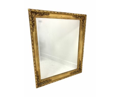 20th century gilt framed wall mirror, floral moulded frame enclosing bevelled plate 71cm x 86cm