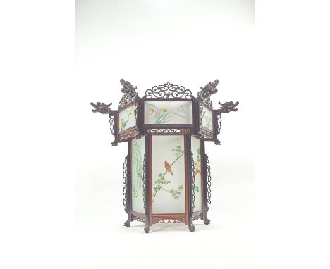 A Chinese carved hardwood and acid etched glass hexagonal pendant light shade with pierced cresting rails over panels, polych