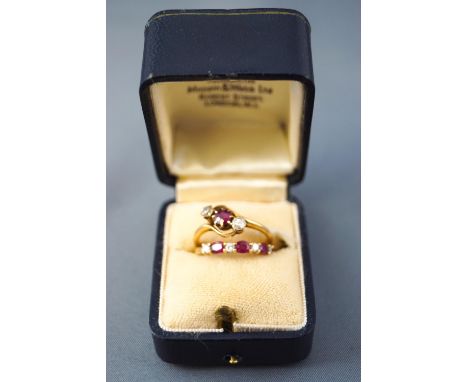 A collection of two yellow metal dress rings consisting of a three stone claw set ruby and old cut diamond ring, hallmarked 1