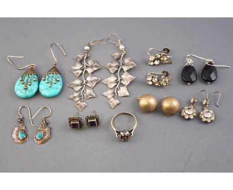 A collection of eight pairs of silver earrings of variable designs together with a hallmarked silver ring with white stones (