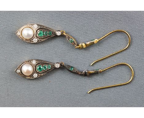 A yellow and white metal pair of drop earrings, set with emeralds, diamonds and a freshwater pearl. Hook fitting. No hallmark